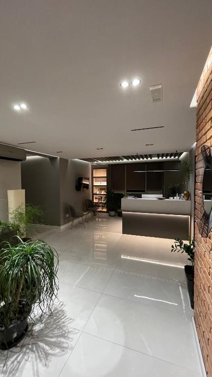 a large living room with a couch and a table at Hotel Oresti Center in Tirana