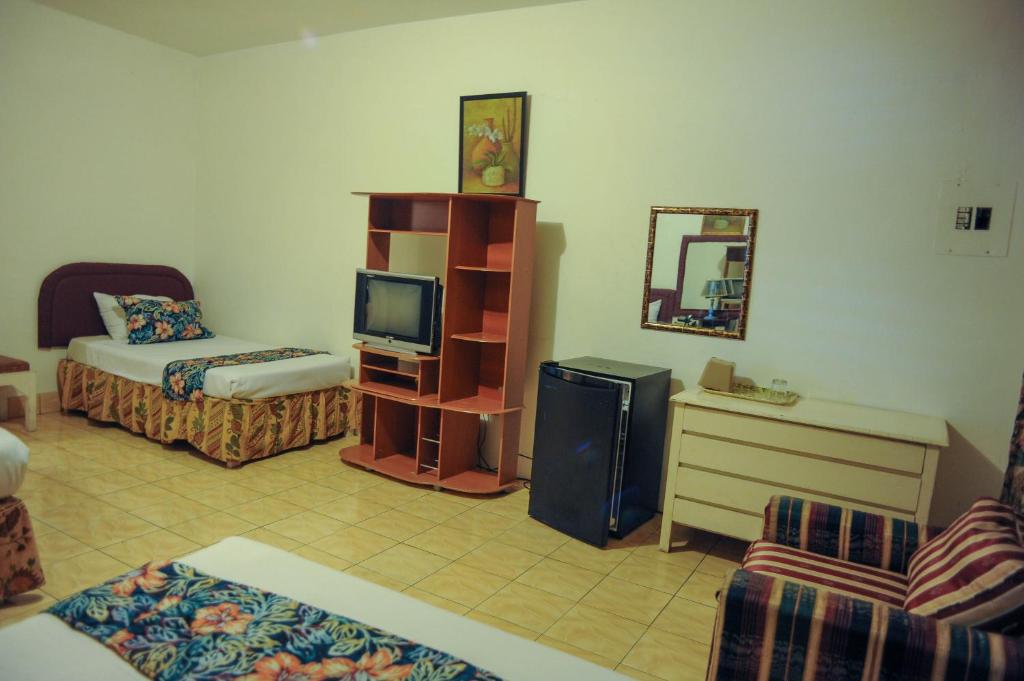 Postel nebo postele na pokoji v ubytování Glorianna Hotel