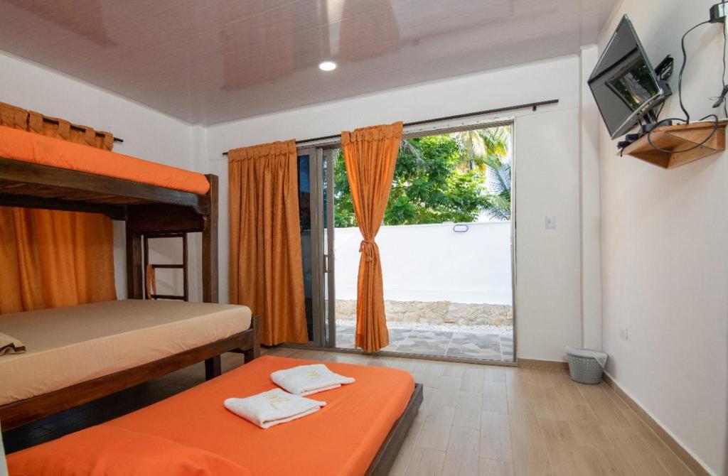 a bedroom with two bunk beds and a large window at ZABDI COVEÑAS in Coveñas