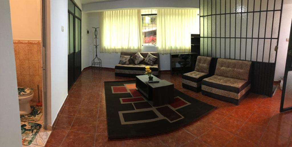 a living room with a couch and a table at Apartamento familiar entero Cusco x5 in Cusco