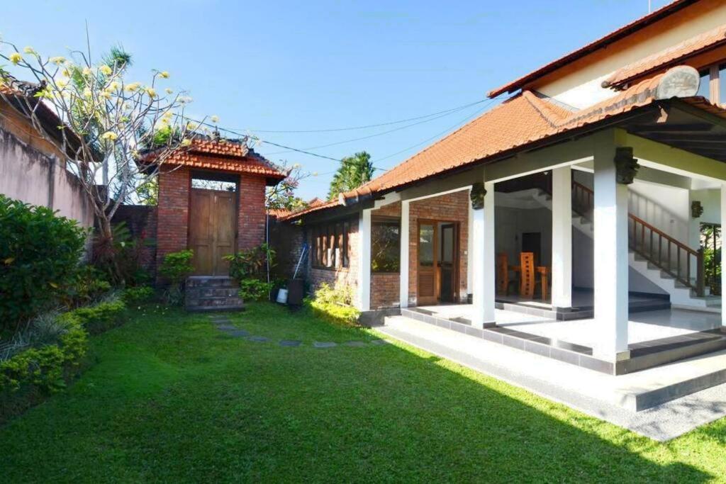 a house with a lawn in front of it at Villa Family in Canggu
