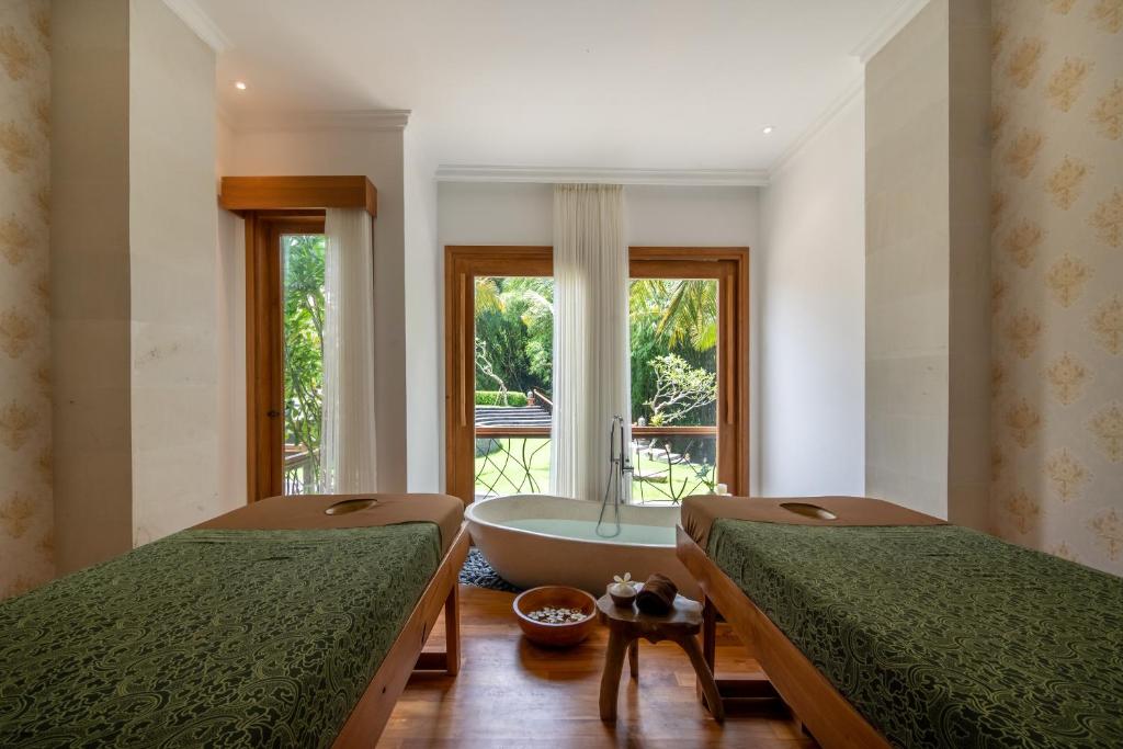 Postel nebo postele na pokoji v ubytování Harsono Boutique Resort Bali