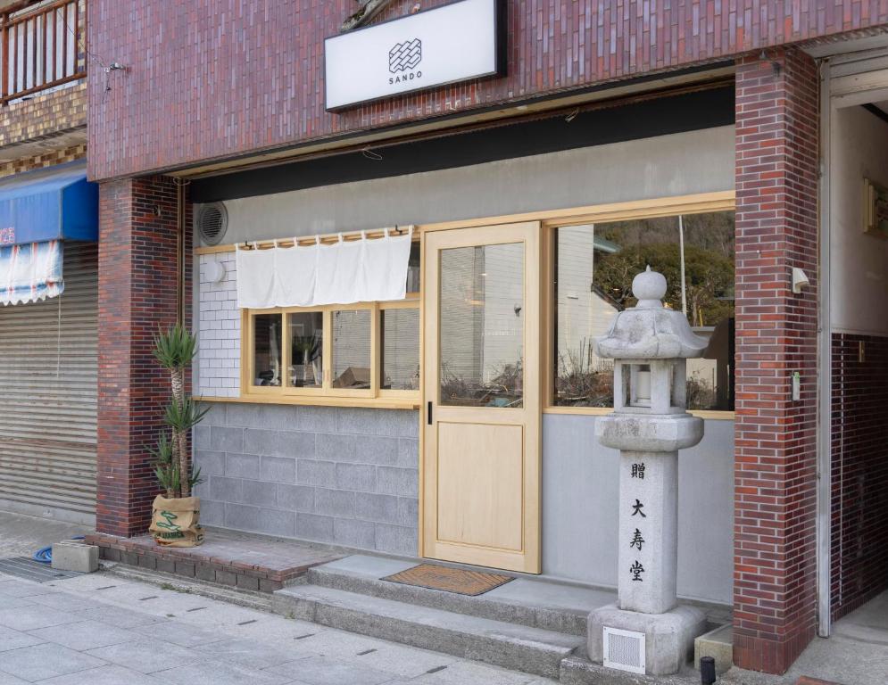 a fire hydrant in front of a building at Coliving & Cafe SANDO in Imabari