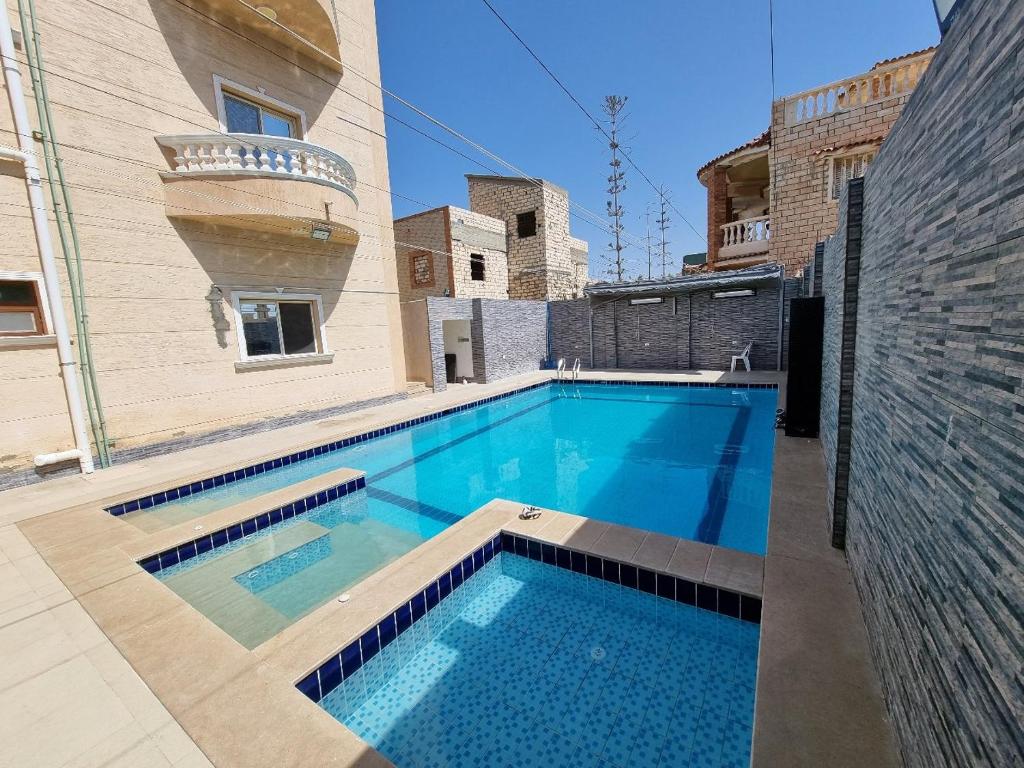 a swimming pool in the middle of a building at فيلا العيلة Villa L-3eela in Abû Zeira