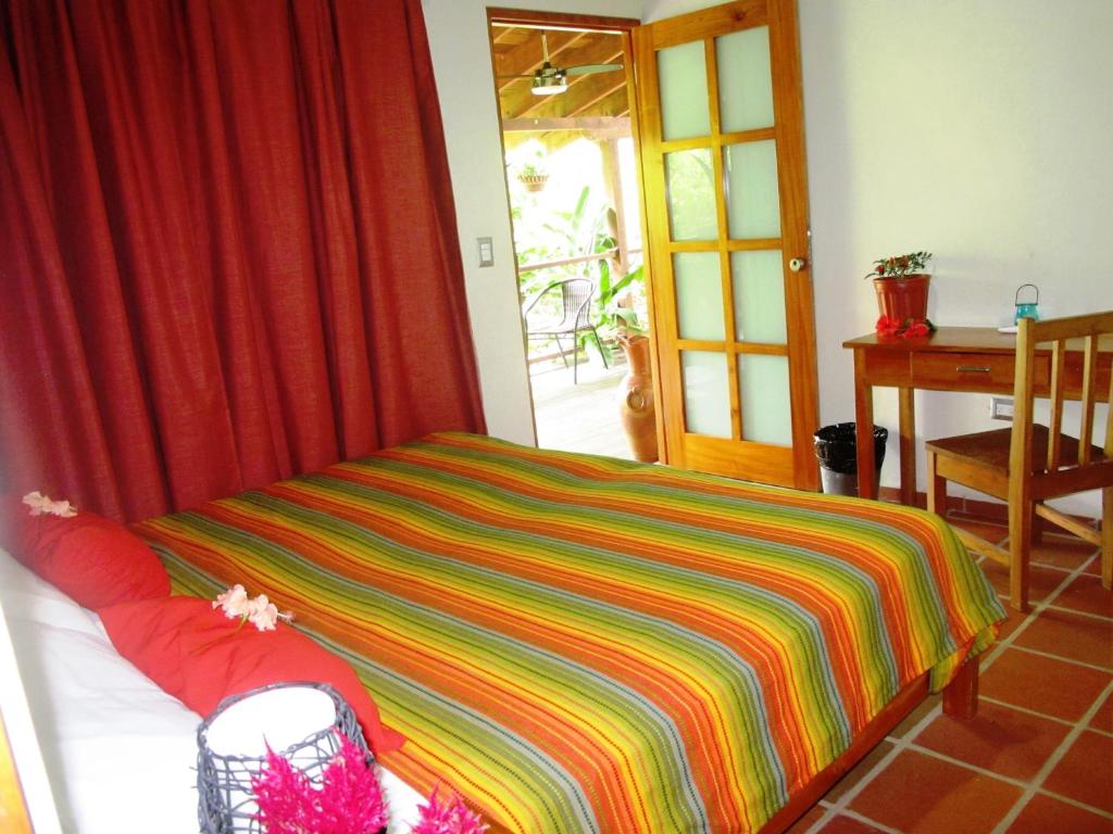 Postel nebo postele na pokoji v ubytování Hotel Iguanito