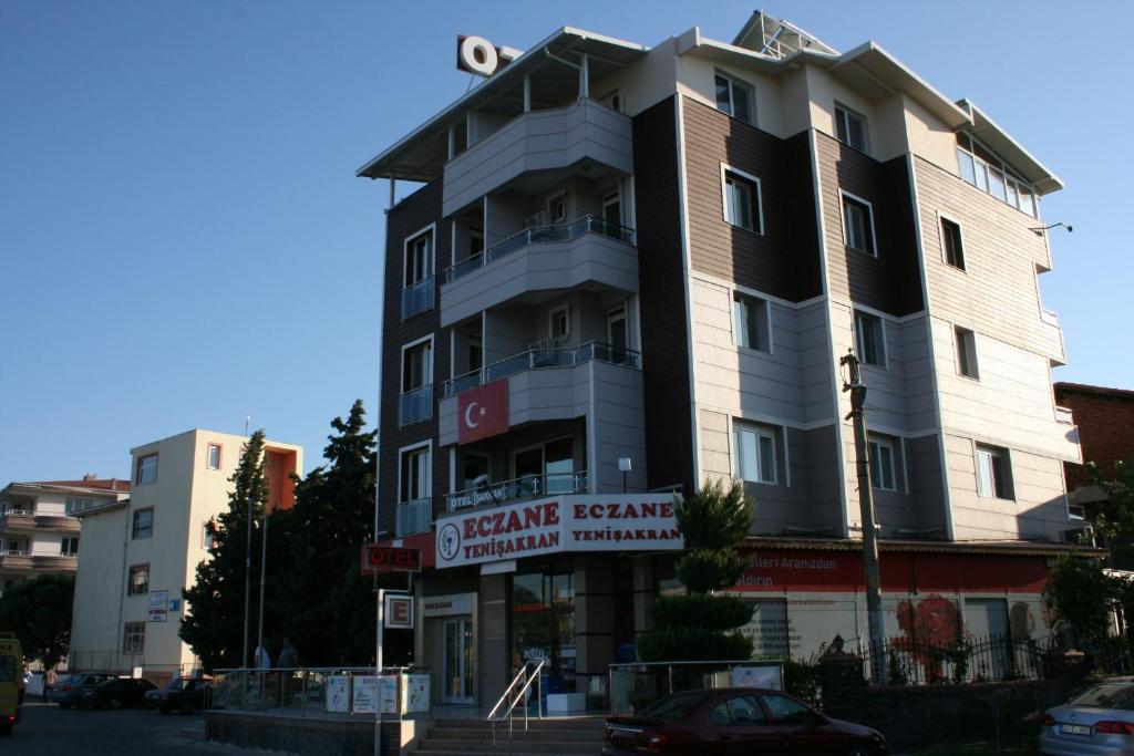 a tall building with a sign in front of it at Sakran Hotel in Yenişakran