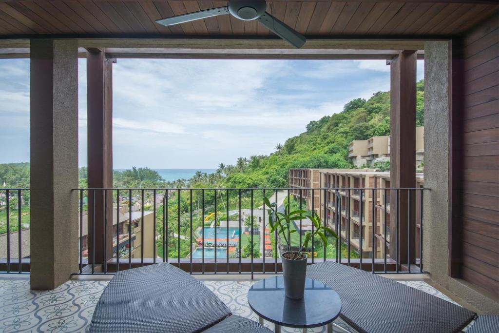 a balcony with a view of the ocean at Sunsuri Phuket - SHA Plus in Nai Harn Beach