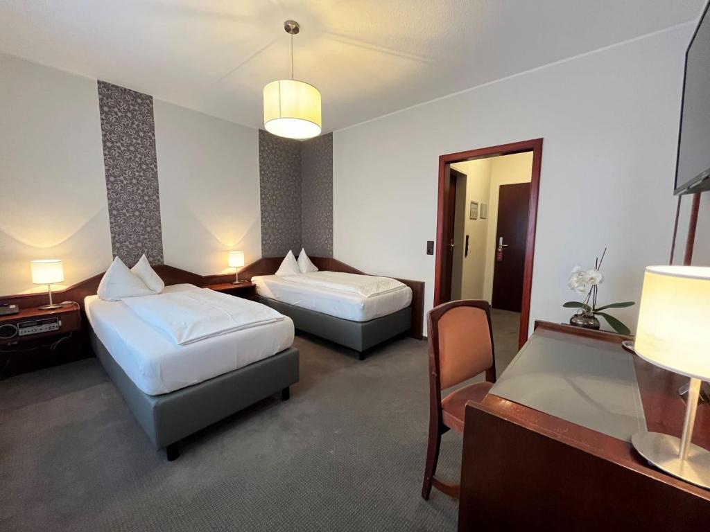 Postel nebo postele na pokoji v ubytování Hotel Garni Geisler