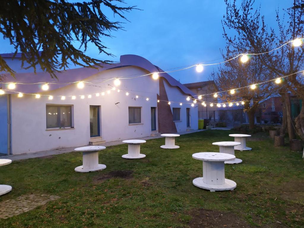 a group of picnic tables in a yard with lights at basilicata al volo in Brindisi di Montagna