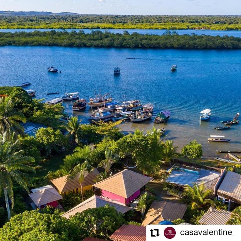 an aerial view of a body of water with boats at Casa Valentine Pousada Itacaré in Itacaré