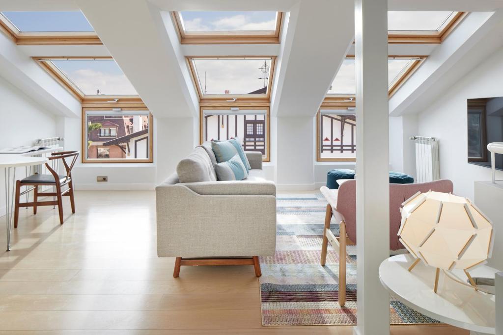 an attic living room with skylights at Villa Loretopea by FeelFree Rentals in San Sebastián