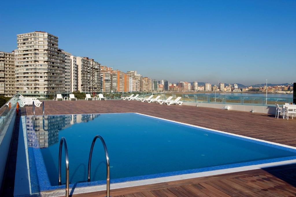 a swimming pool on the roof of a building at NH Gijón in Gijón