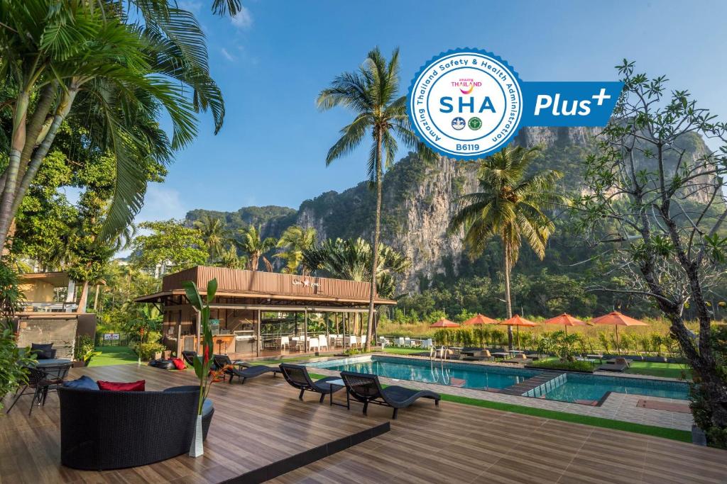 a resort with a pool and a sign that reads shka plus at Aonang Paradise Resort Krabi in Ao Nang Beach