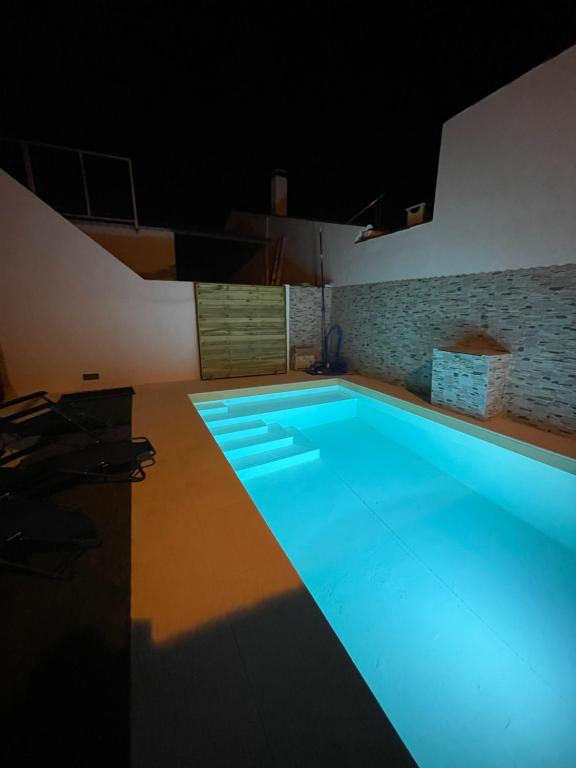 a large swimming pool with blue lighting in a room at Casa da Matriz in Vidigueira