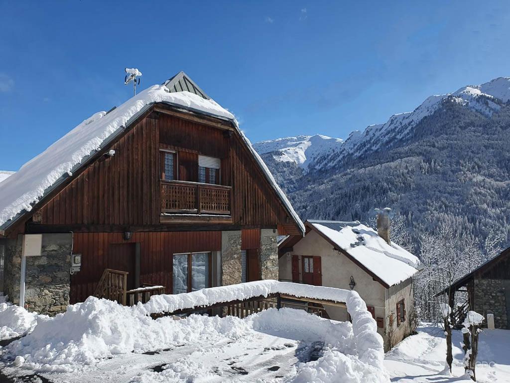a building with snow on the ground in front of it at Chalet Le Sambuis in Saint-Colomban-des-Villards
