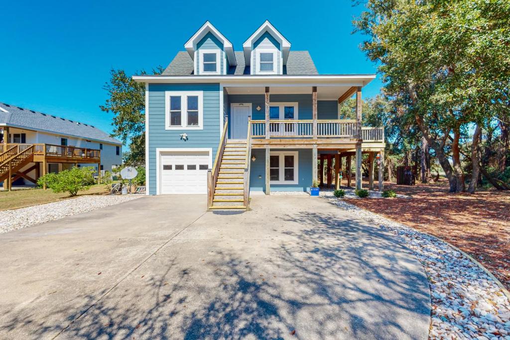 a large blue house with a porch and a driveway at BlueDream in Kill Devil Hills