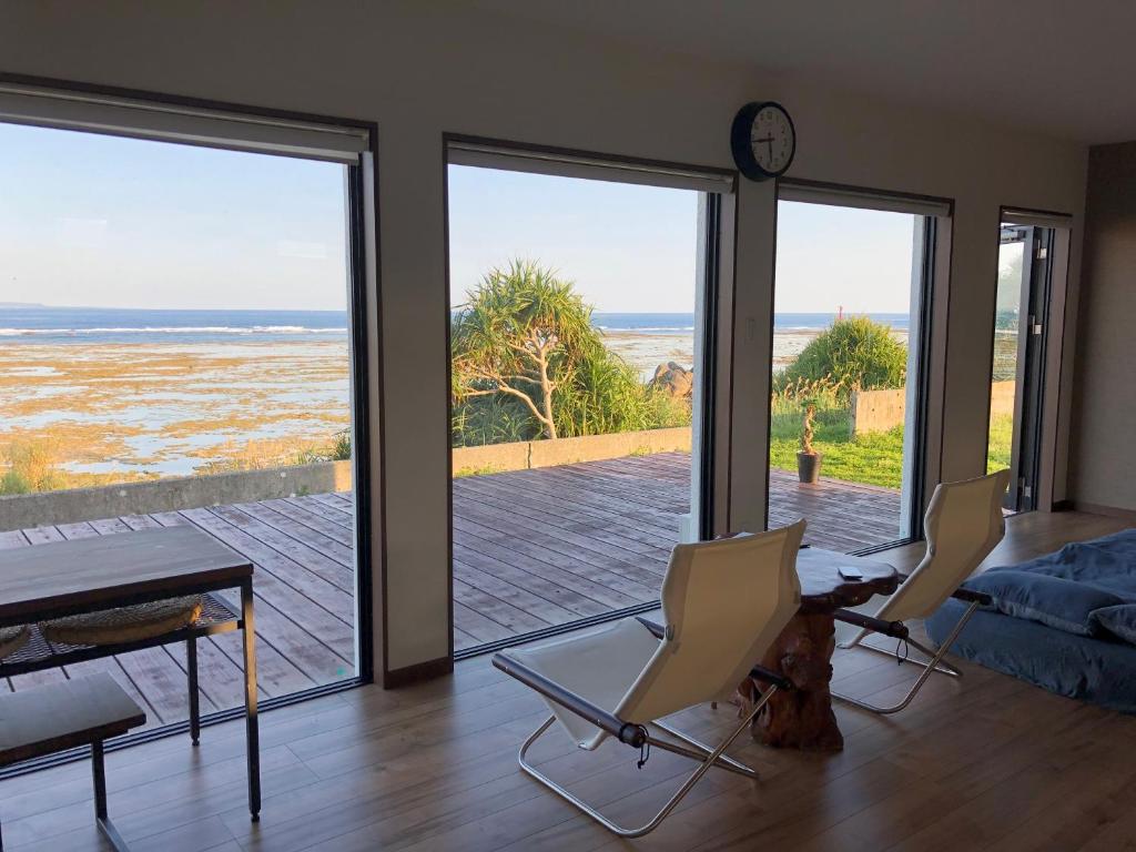 a living room with a view of the ocean at ゴールデンマイルヴィラ in Amami