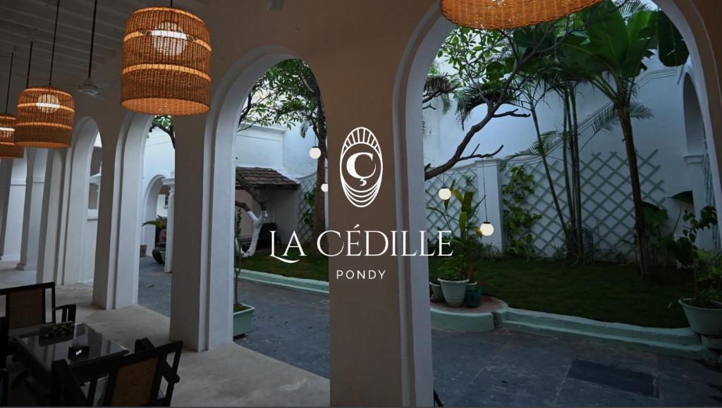 een bord voor een patio in een huis bij La Cedille - French Heritage House in Pondicherry