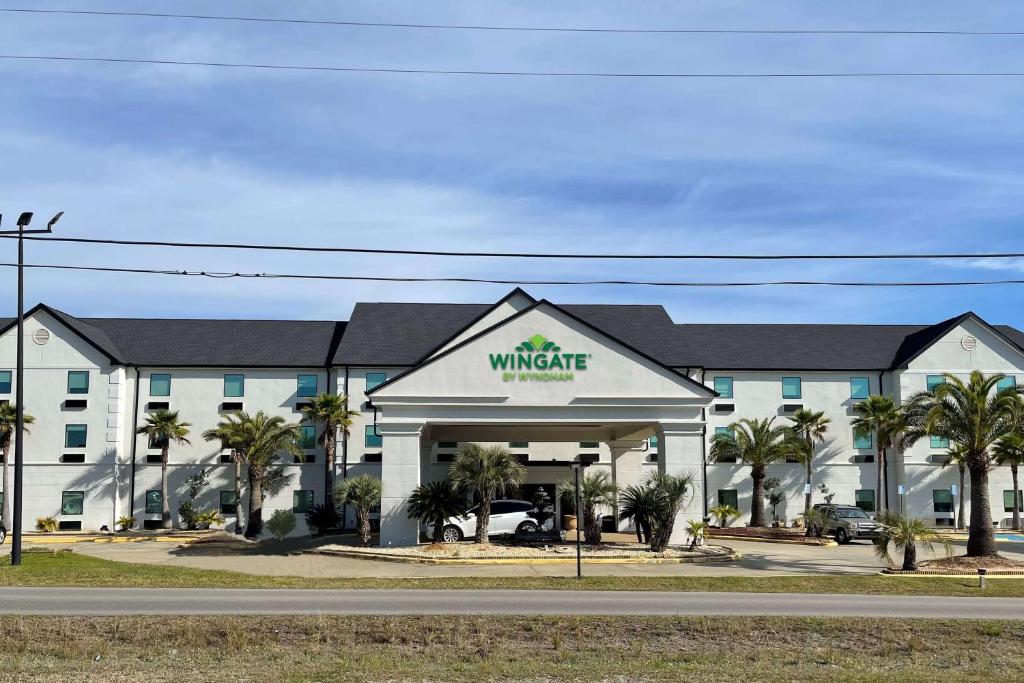 a building with a walmart sign in front of a road at Wingate by Wyndham Biloxi - Ocean Springs in Biloxi
