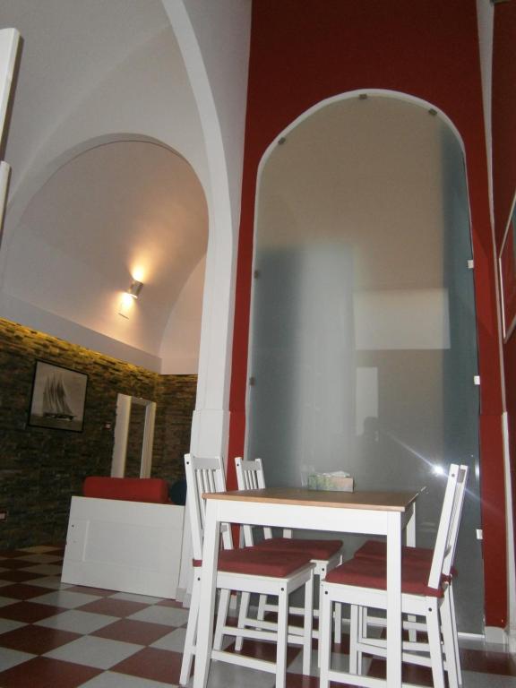 a dining room with a white table and chairs at Appartamento vacanze La Marina in Giovinazzo