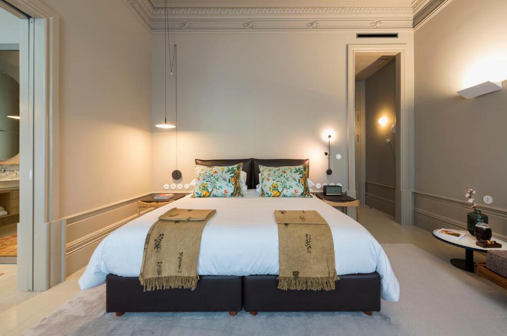 a bedroom with a large white bed with two pillows at Jardins do Porto - by Unlock Hotels in Porto