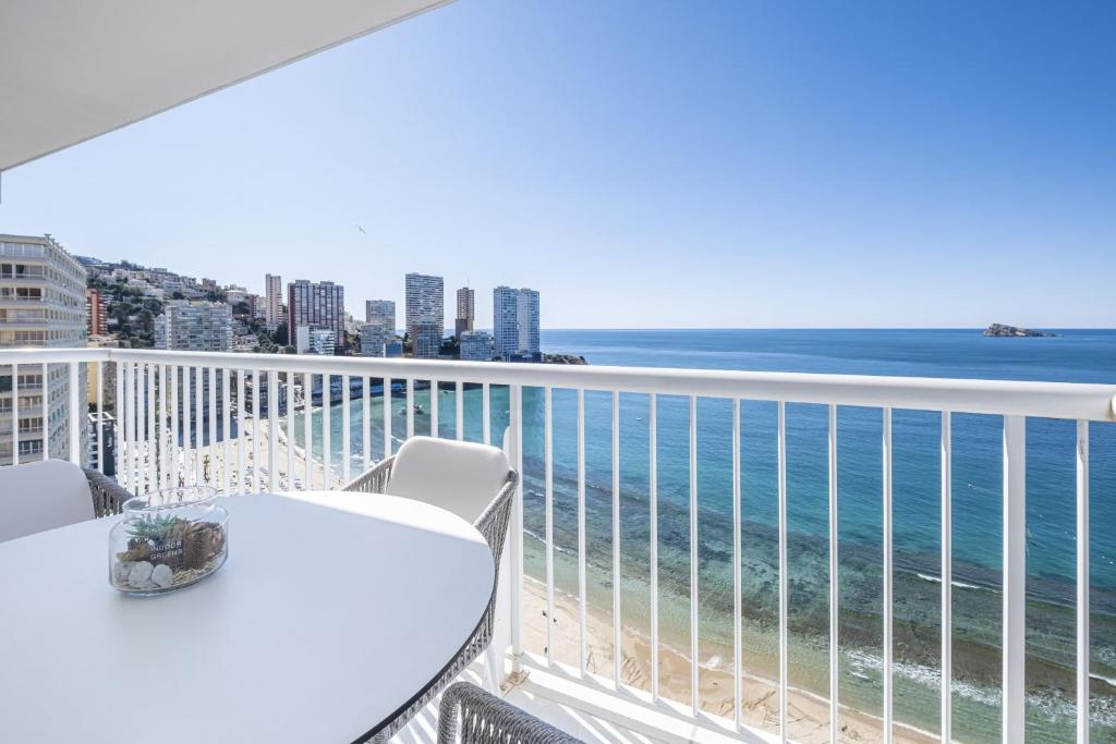 a balcony with a table and chairs and the ocean at Veracruz 20-D Deluxe Apartment Levante Beach in Benidorm