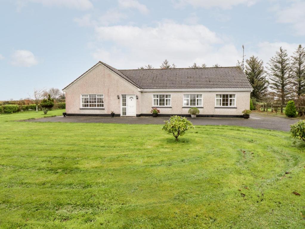 a house with a large yard in front of it at Dromore West Cottage in Dromore West