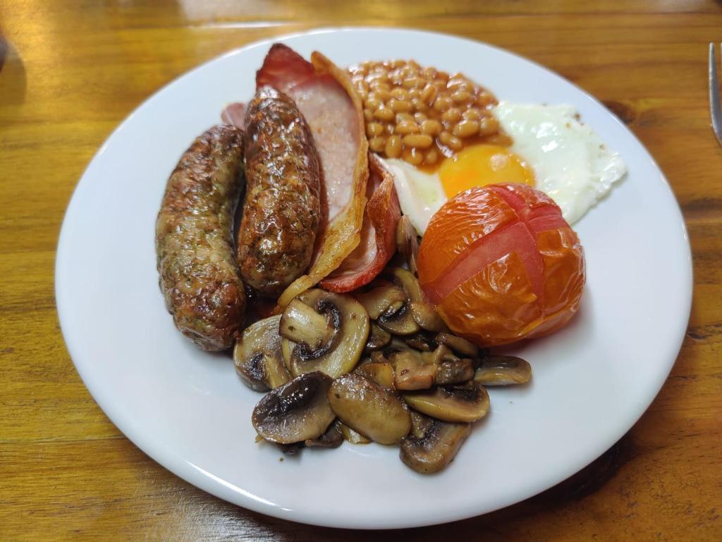 a plate of breakfast food with eggs sausage beans and mushrooms at Woolpack Inn in Chichester