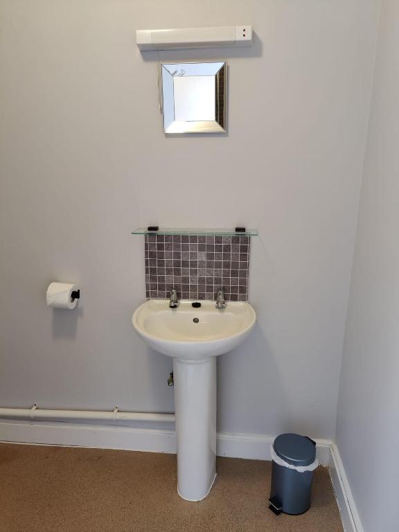 a white bathroom with a sink and a window at Woolpack Inn in Chichester