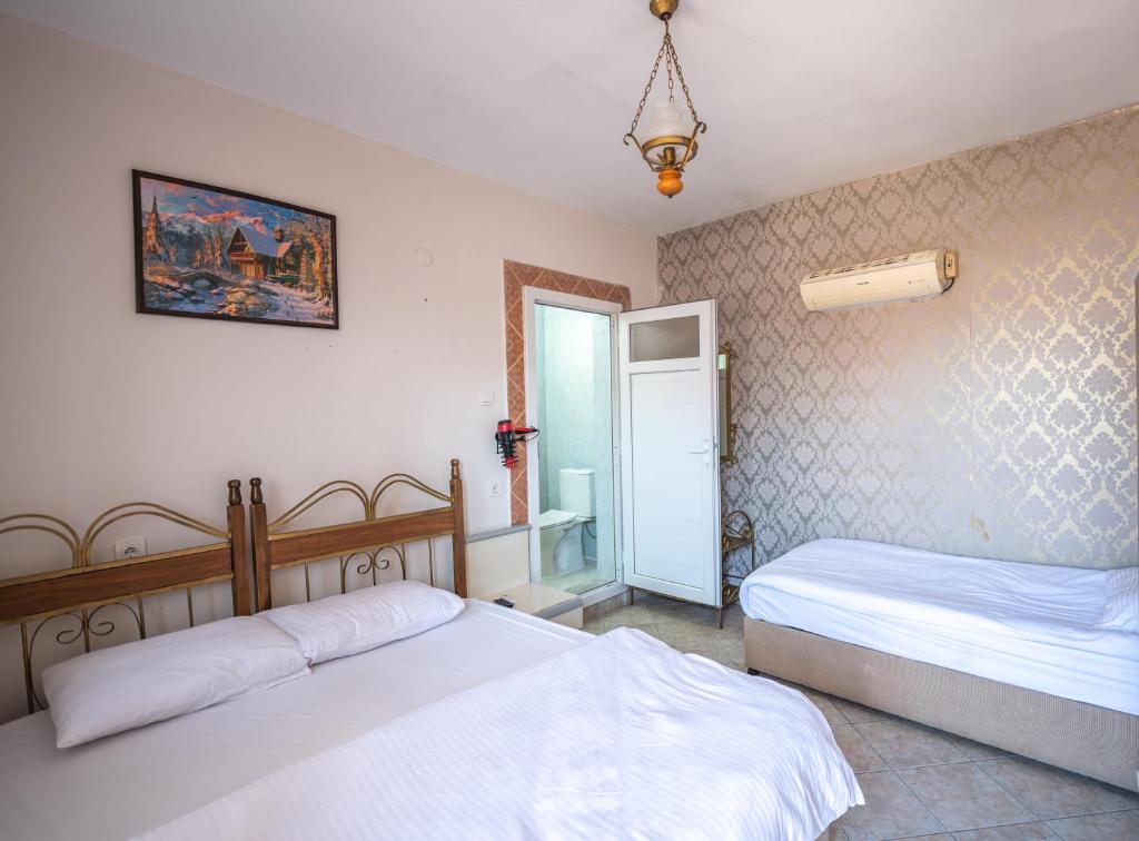 Postel nebo postele na pokoji v ubytování Anz Guest House Pansiyon