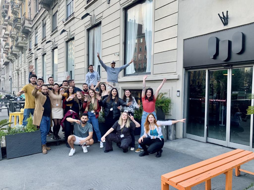a group of people posing for a picture in front of a building at QUO Milano in Milan