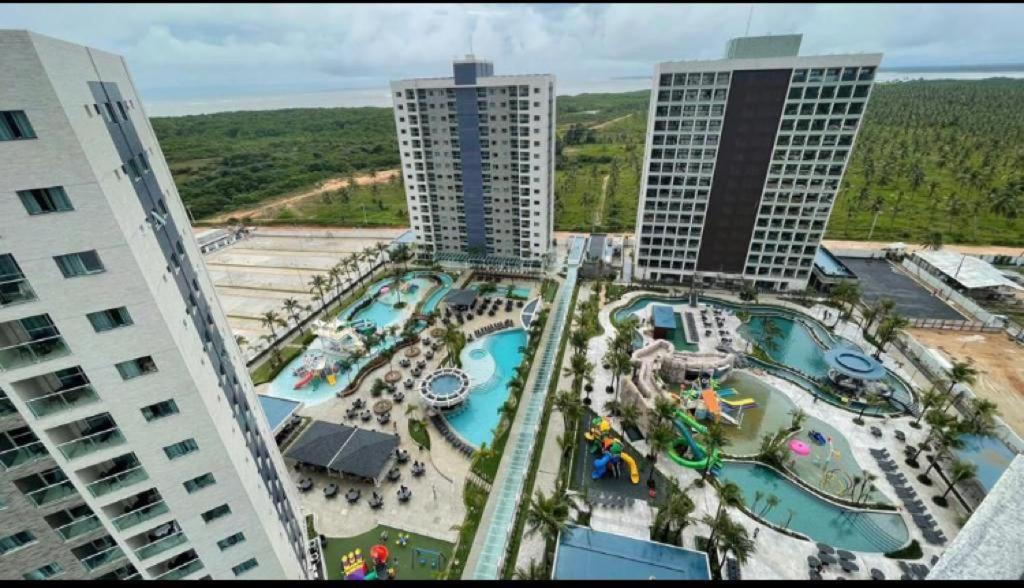 an aerial view of a swimming pool with two tall buildings at Salinas premium Resort in Salinópolis