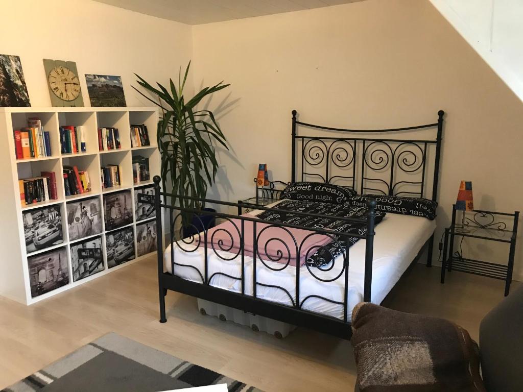 a bedroom with a black bed and a book shelf at Familienfreundliche Wohnung in Wewer in Paderborn
