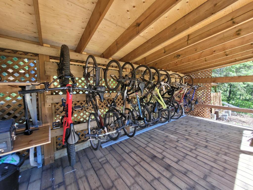 a row of bikes hanging on a rack in a building at Oberge Inn Val-David in Val-David