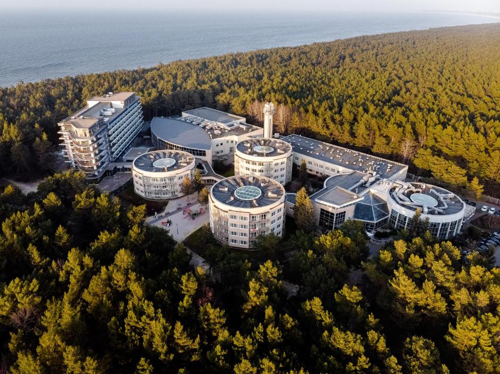an aerial view of a building in the woods at Hotel Senator in Dźwirzyno