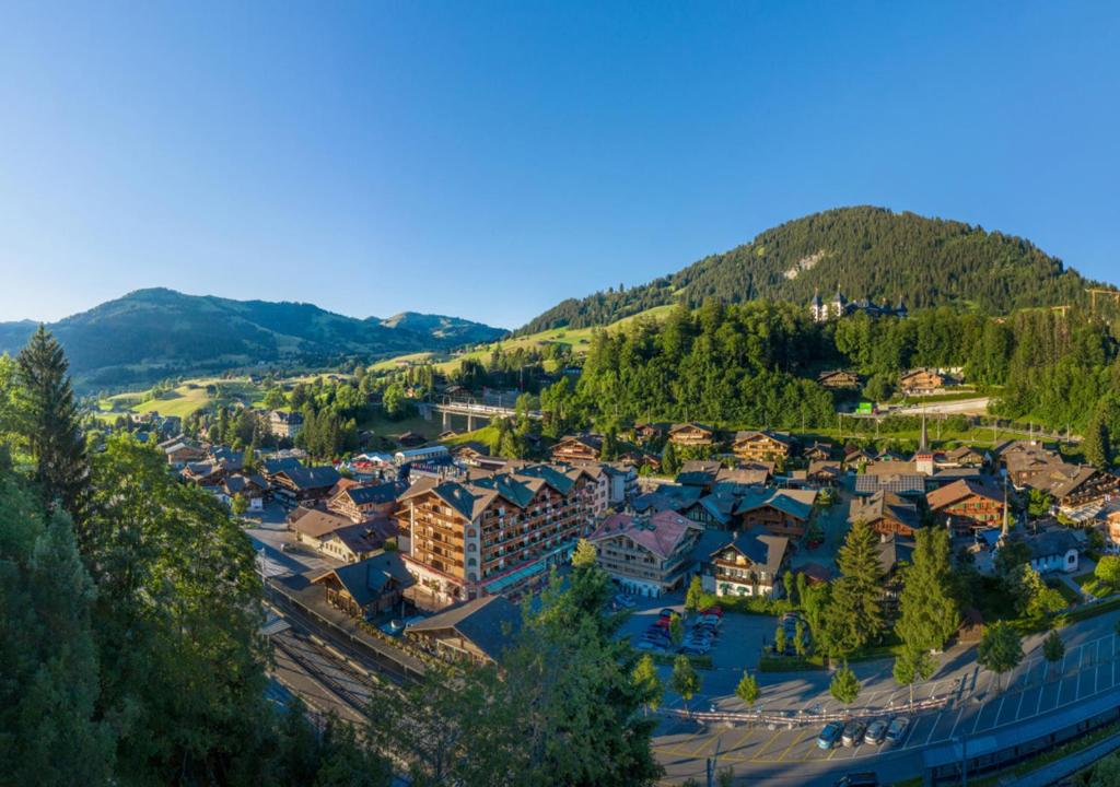 an aerial view of a resort town in the mountains at Bernerhof Swiss Quality Hotel Gstaad in Gstaad