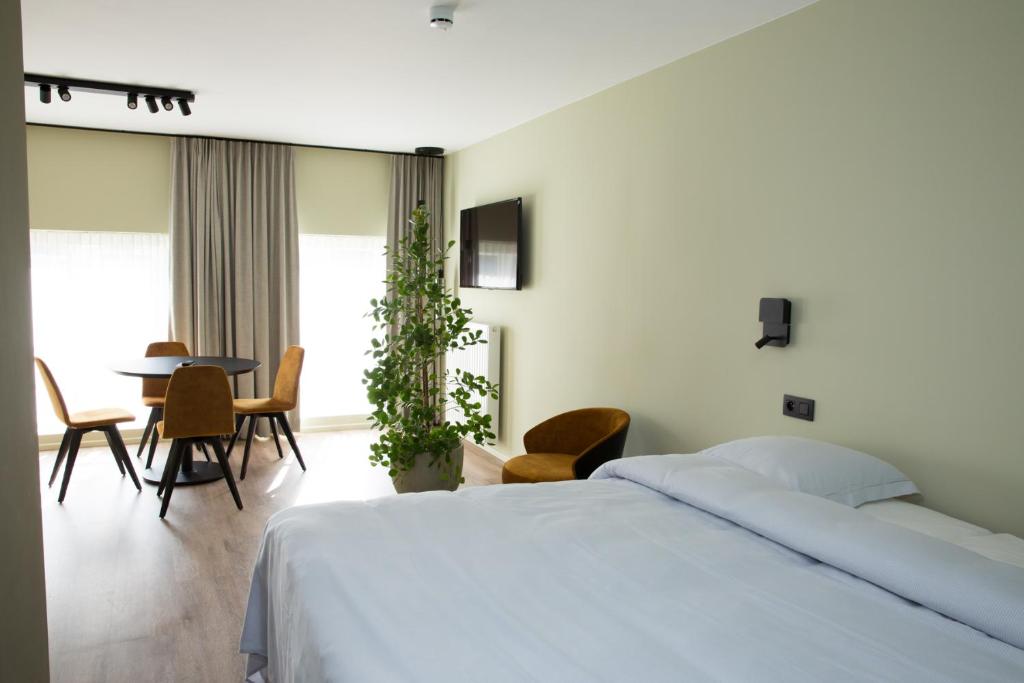 Postel nebo postele na pokoji v ubytování Appart hôtel En Ville