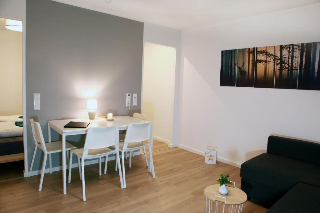 a living room with a table and chairs and a couch at Fewo Ausspann in Stryck