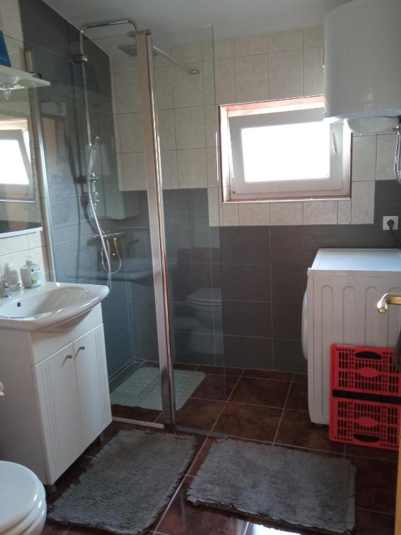 a bathroom with a shower and a sink and a toilet at KATY&MLADEN in Baška