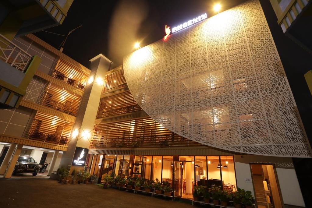 a building with a lit up facade at night at The Phoenix Residency in Shillong
