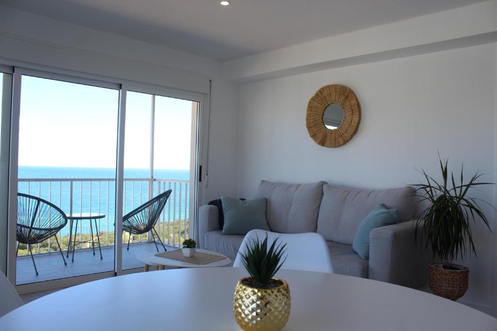 a living room with a couch and a table at Calpe Beachview in Calpe