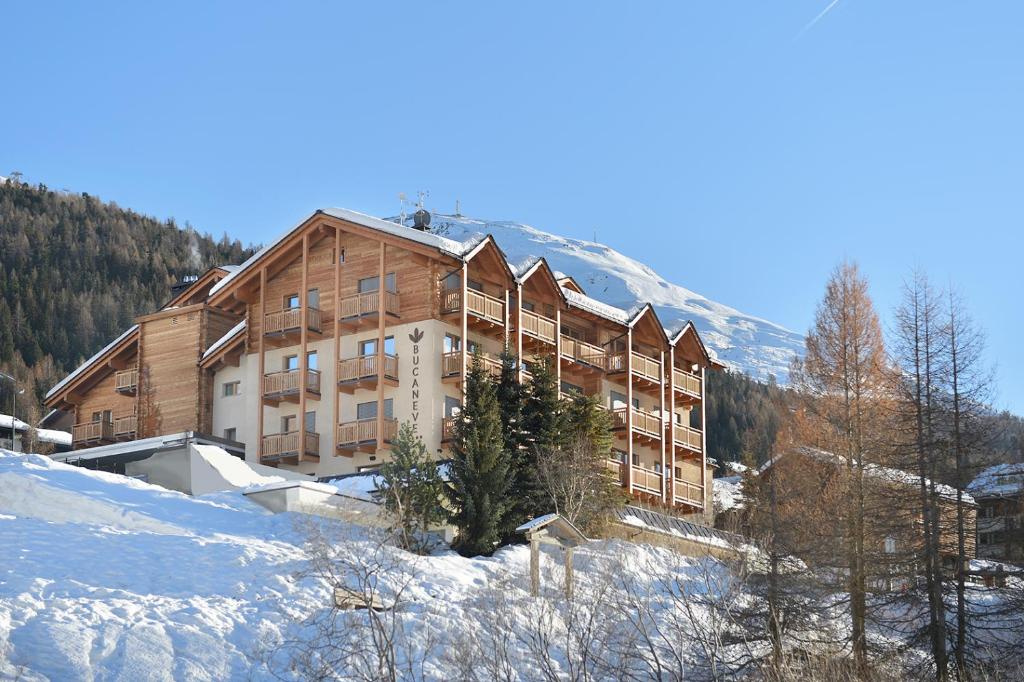 a large building on top of a snow covered mountain at Hotel Bucaneve in Livigno