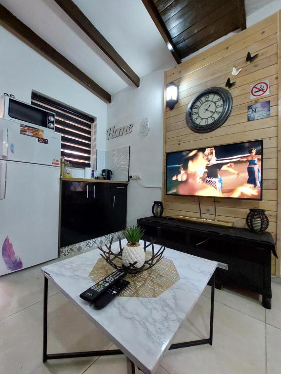 a living room with a large tv and a table at AN edom suite in Eilat