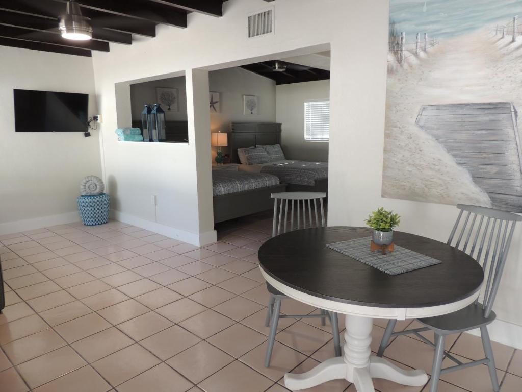 a living room with a table and chairs at Sands of Islamorada in Islamorada