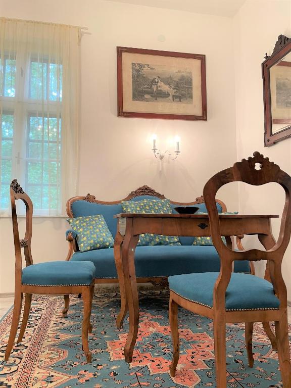 a dining room with a table and two chairs at Villa Bagolyvár in Balatonszemes