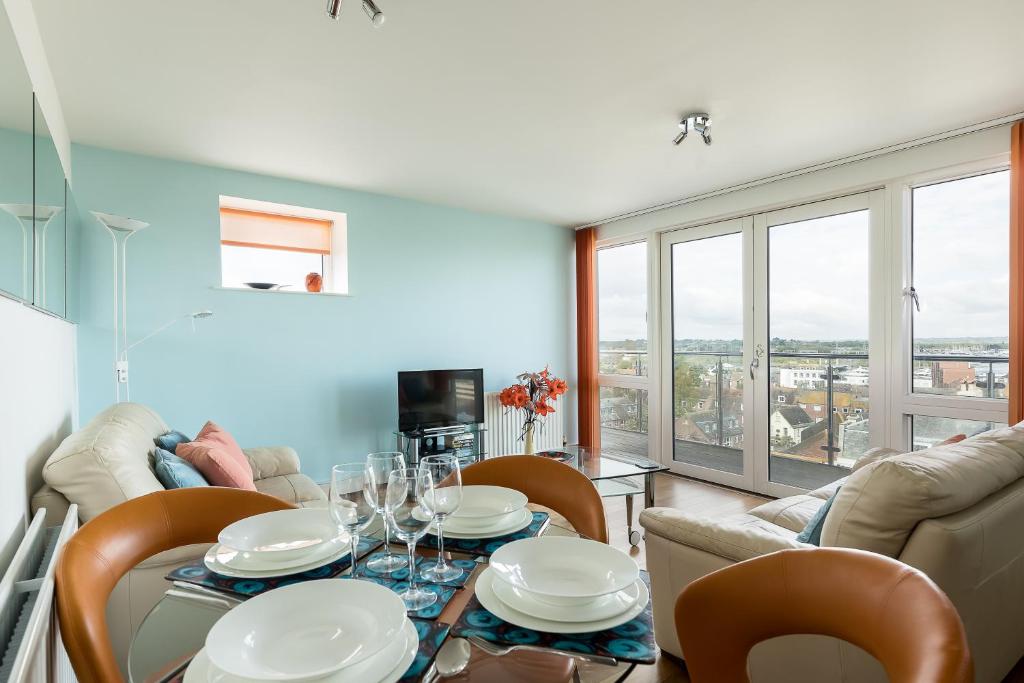 a dining room with a table and chairs at Ocean Escape in Poole