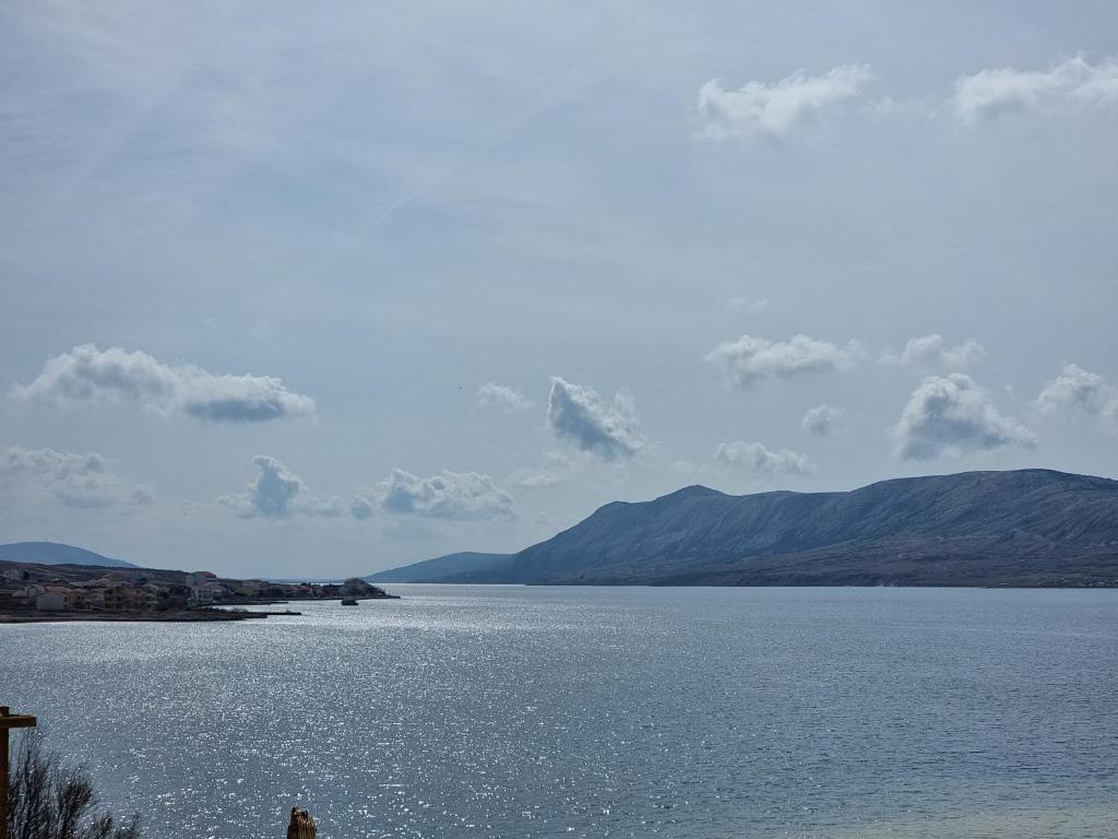 a large body of water with mountains in the background at Apartment DIANA - Vidalići in Kustići