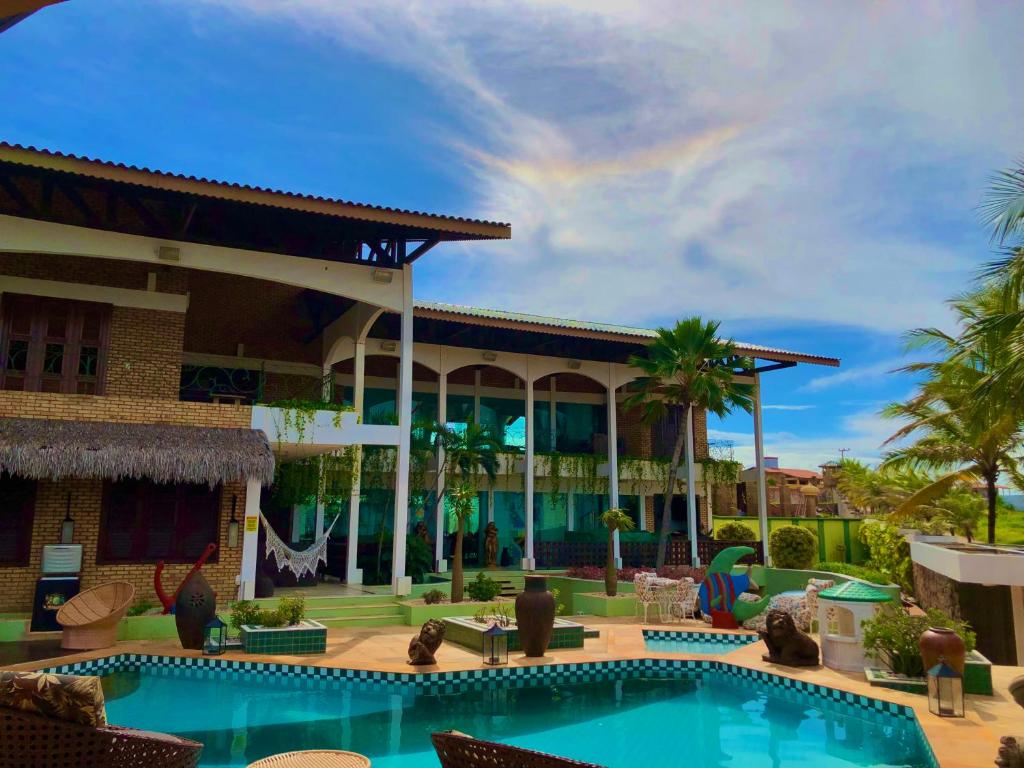 a view of a resort with a swimming pool at Hotel Mansão Marcieri in Aquiraz