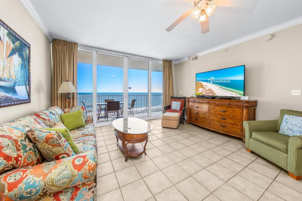 a living room with a couch and a flat screen tv at San Carlos Unit 607 in Gulf Shores