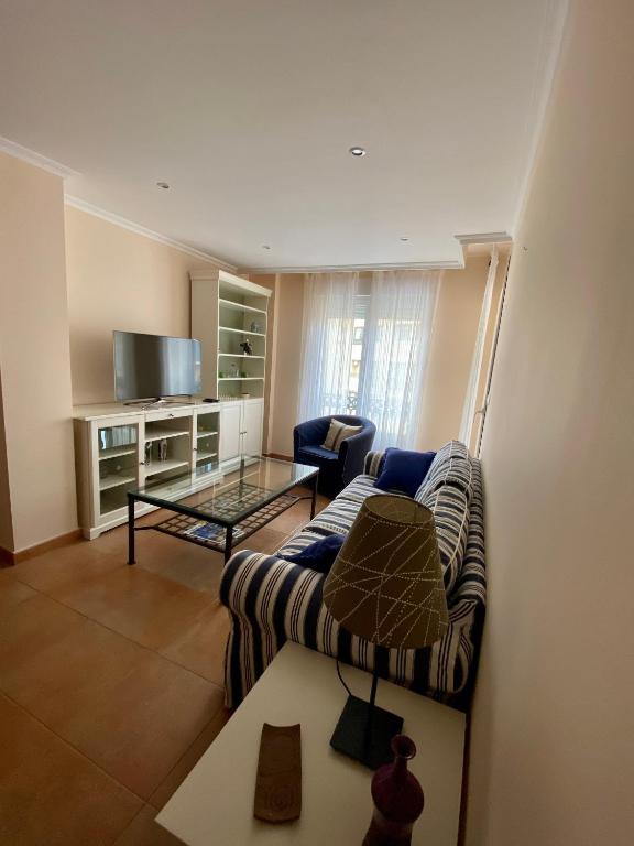 a living room with a couch and a table at Apartamento Marexada Foz in Foz